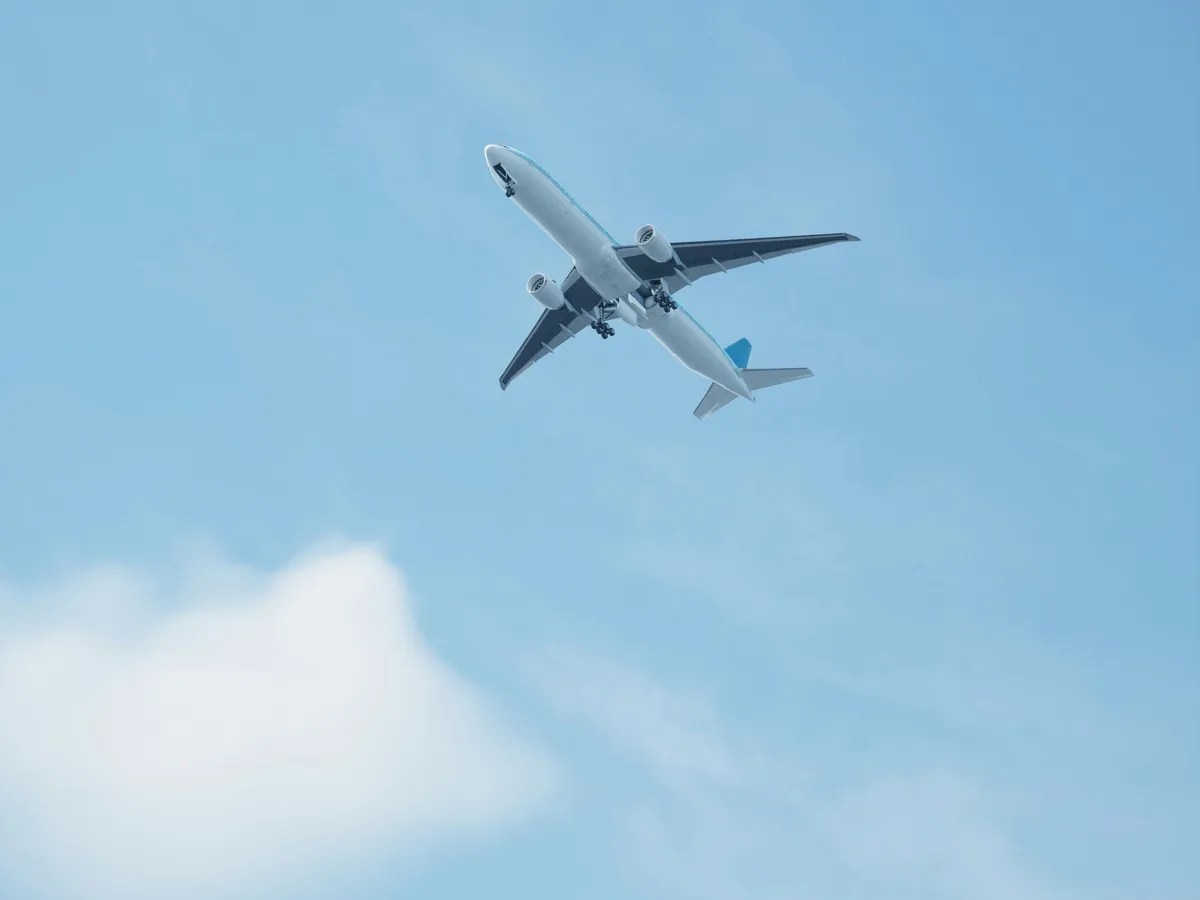 An airliner climbing into a clear blue sky