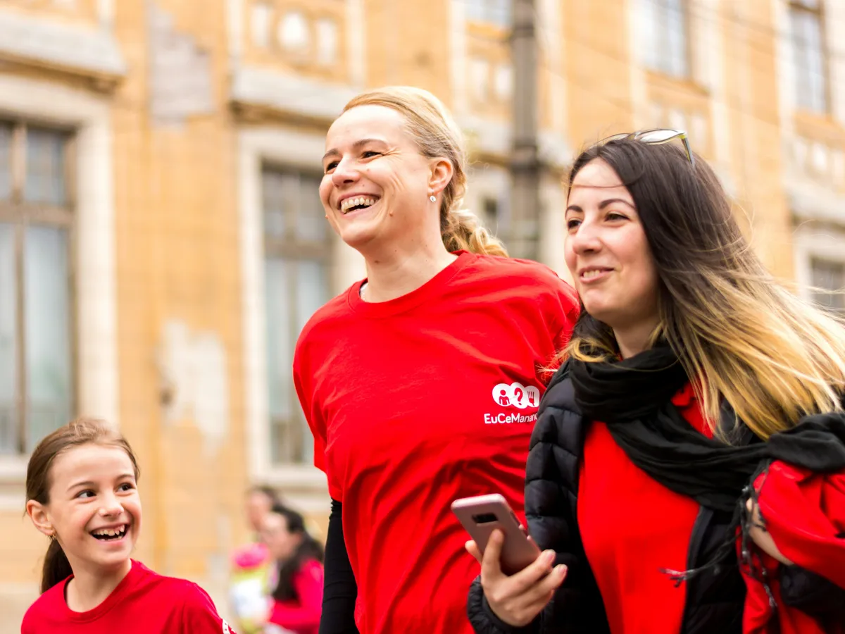 Smiling volunteers in red shirts at a community fundraiser