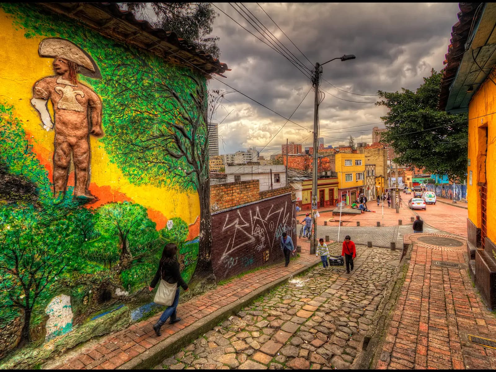 A cobbled street with a large mural in Bogotá's La Candelaria district