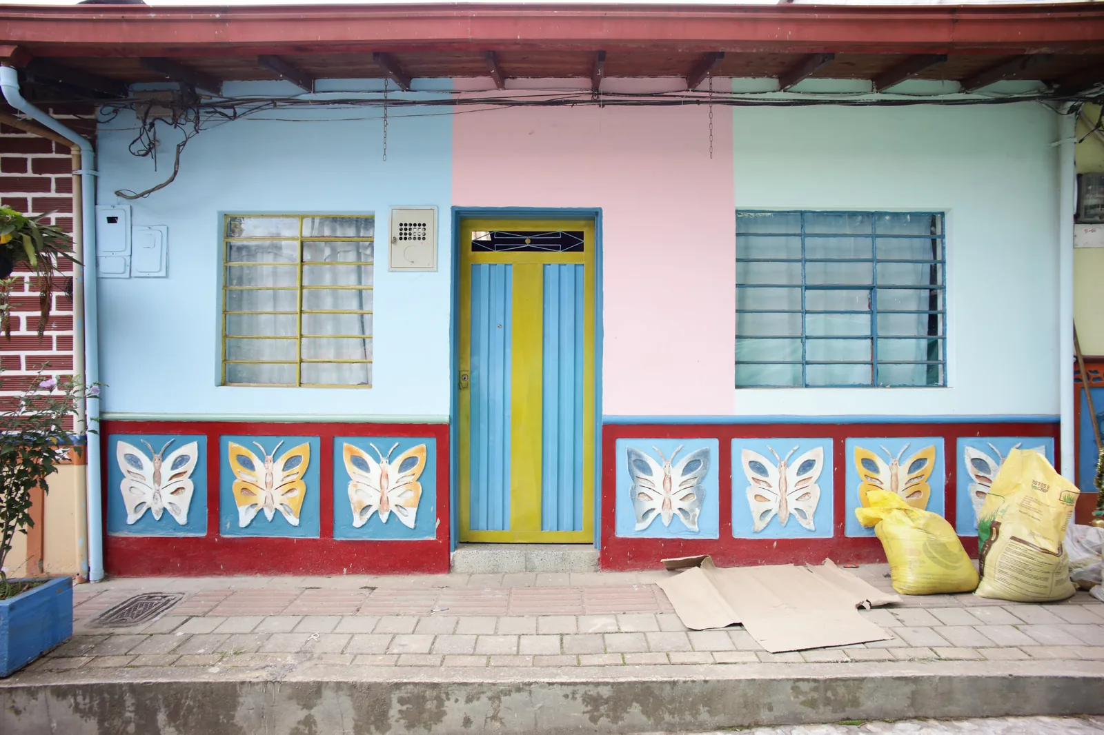 A brightly painted house front with decorated panels in Guatapé