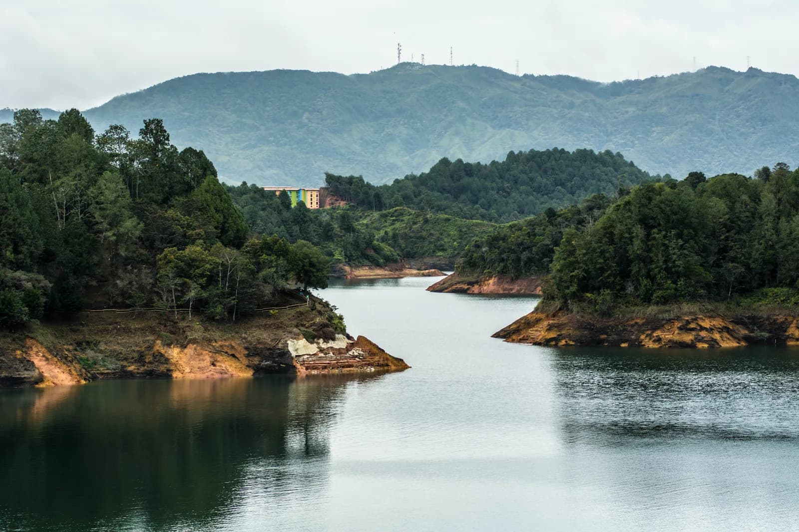 Calm green water and wooded hills on the Guatapé reservoir