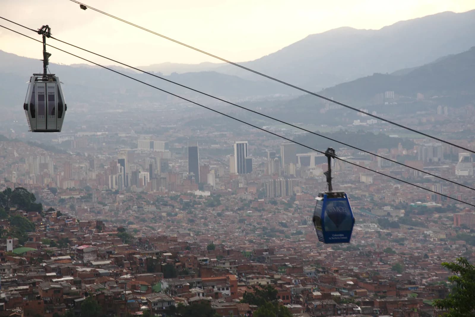 Metrocable cabins hanging above the hillside neighbourhoods of Medellín
