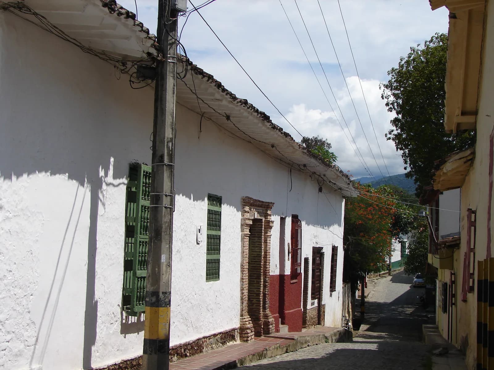 A narrow colonial street of white houses with wooden windows in Santa Fe de Antioquia