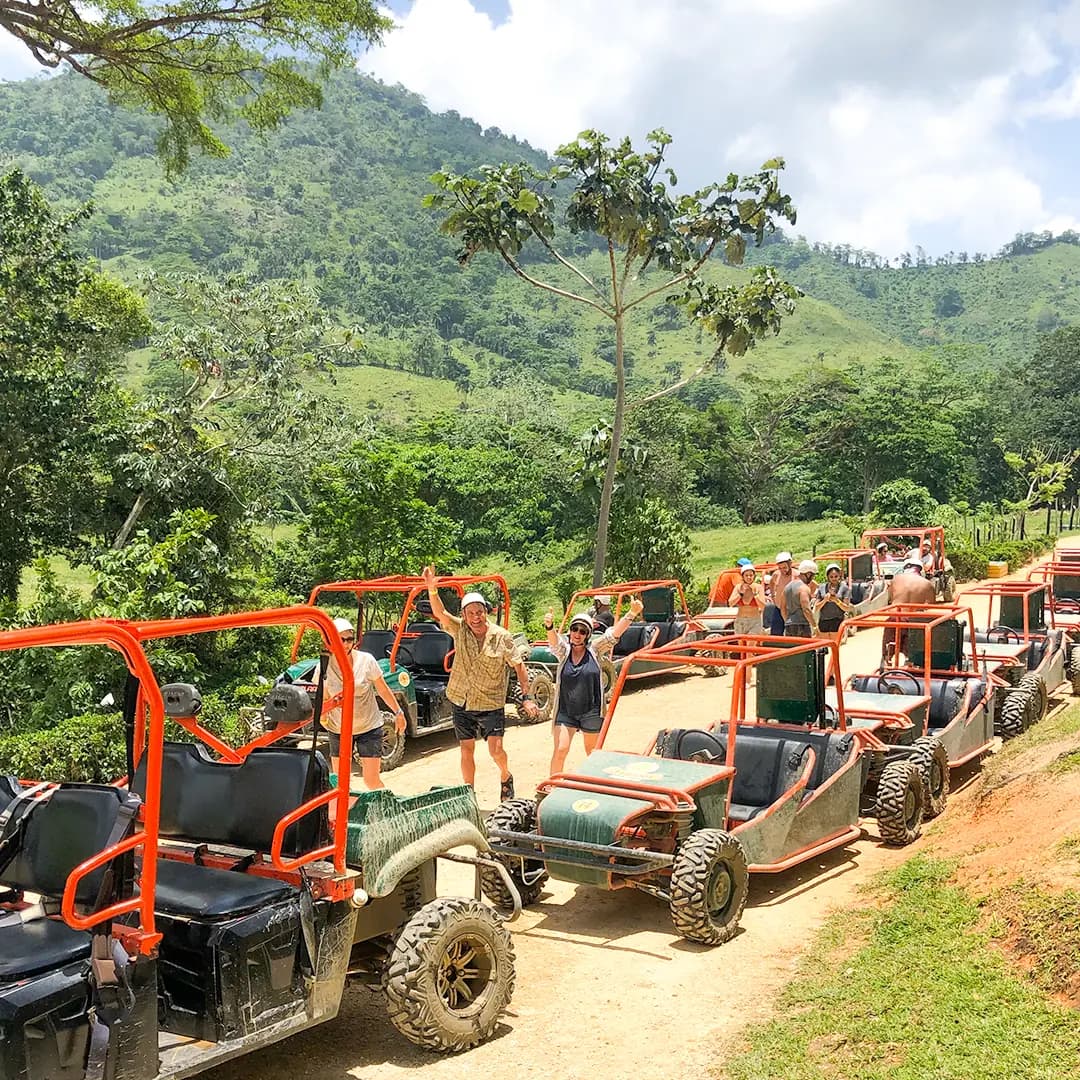 A convoy of off-road buggies lined up on a country track