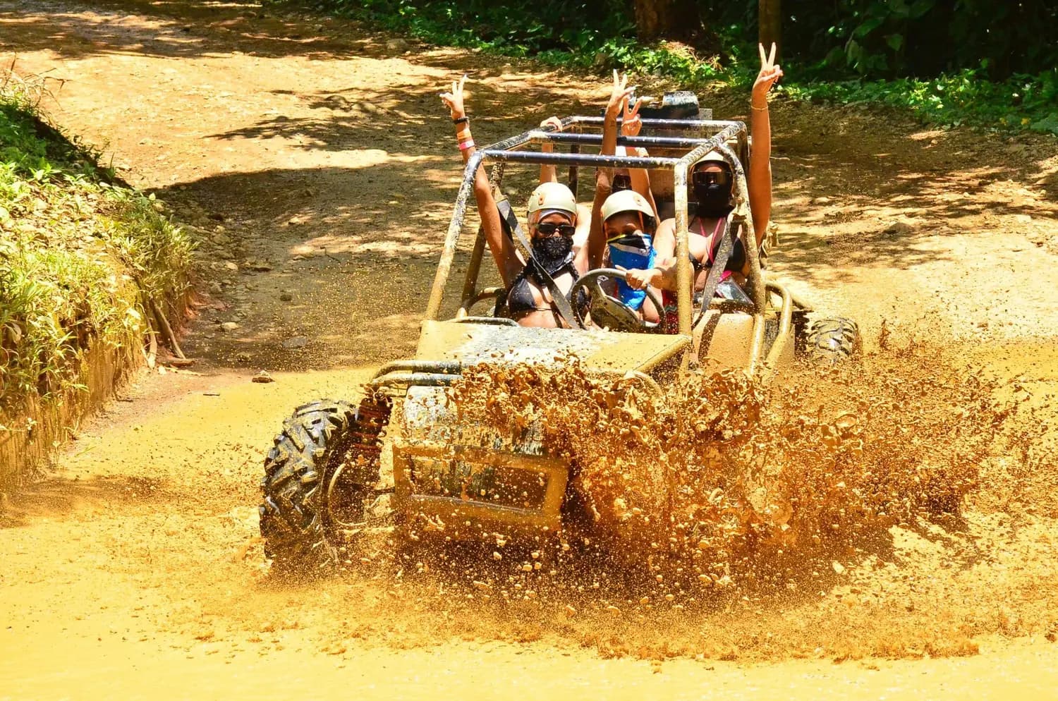 A buggy splashing through a muddy off-road trail