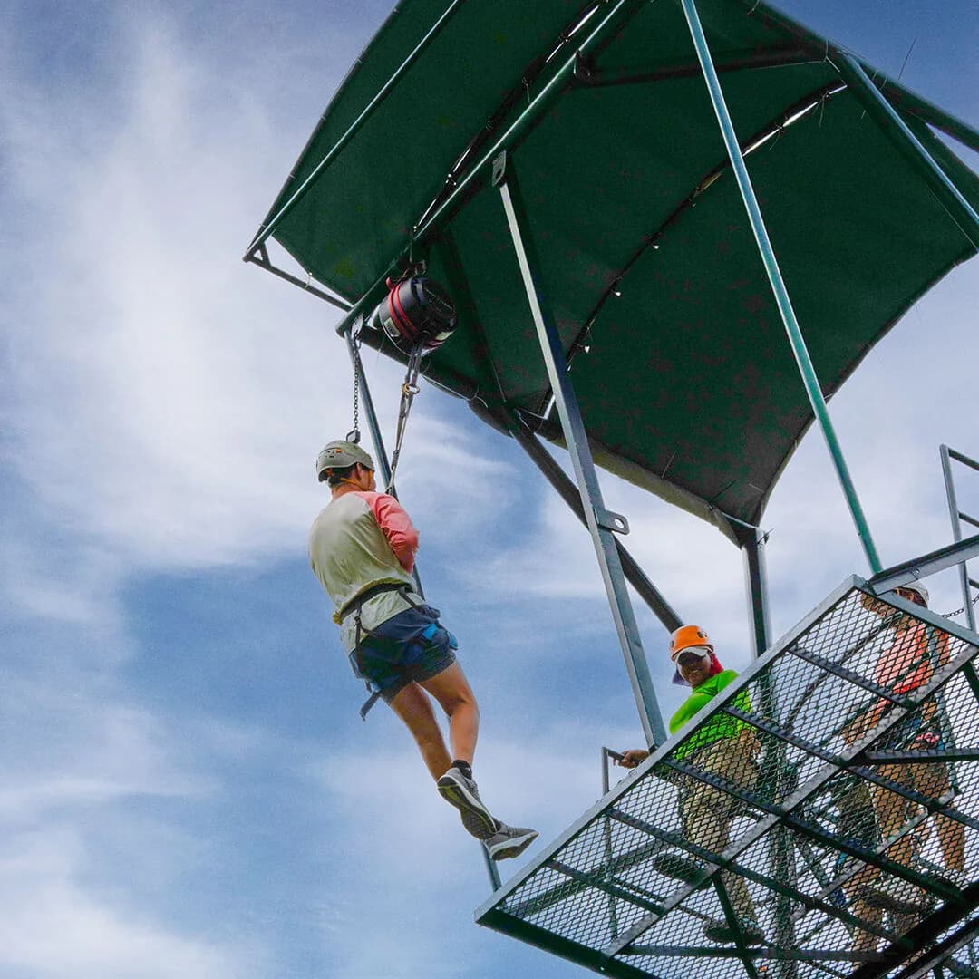 A visitor free-falling from a jump tower on a safety line