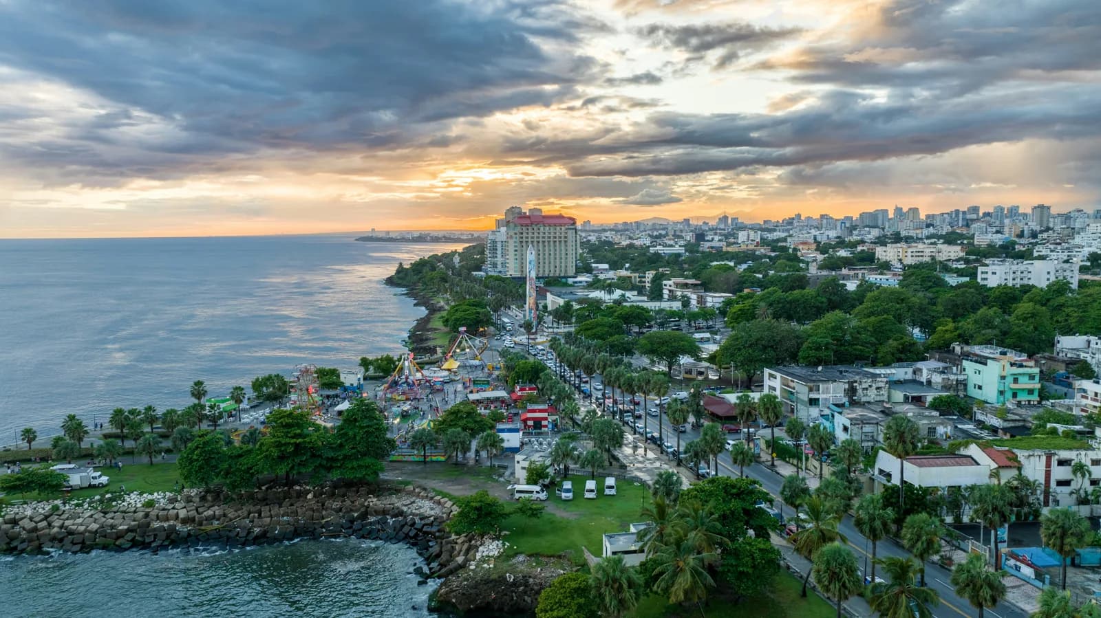 A coastal city beneath a glowing evening sky