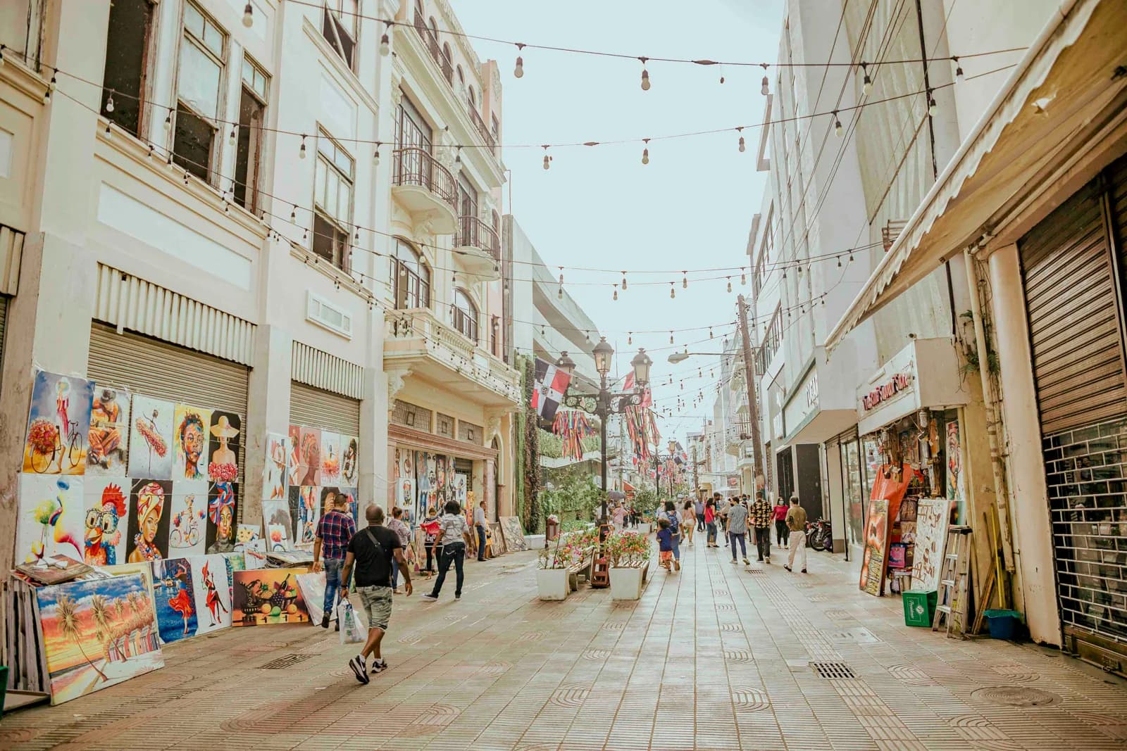 People walking along a pedestrian street with local shops