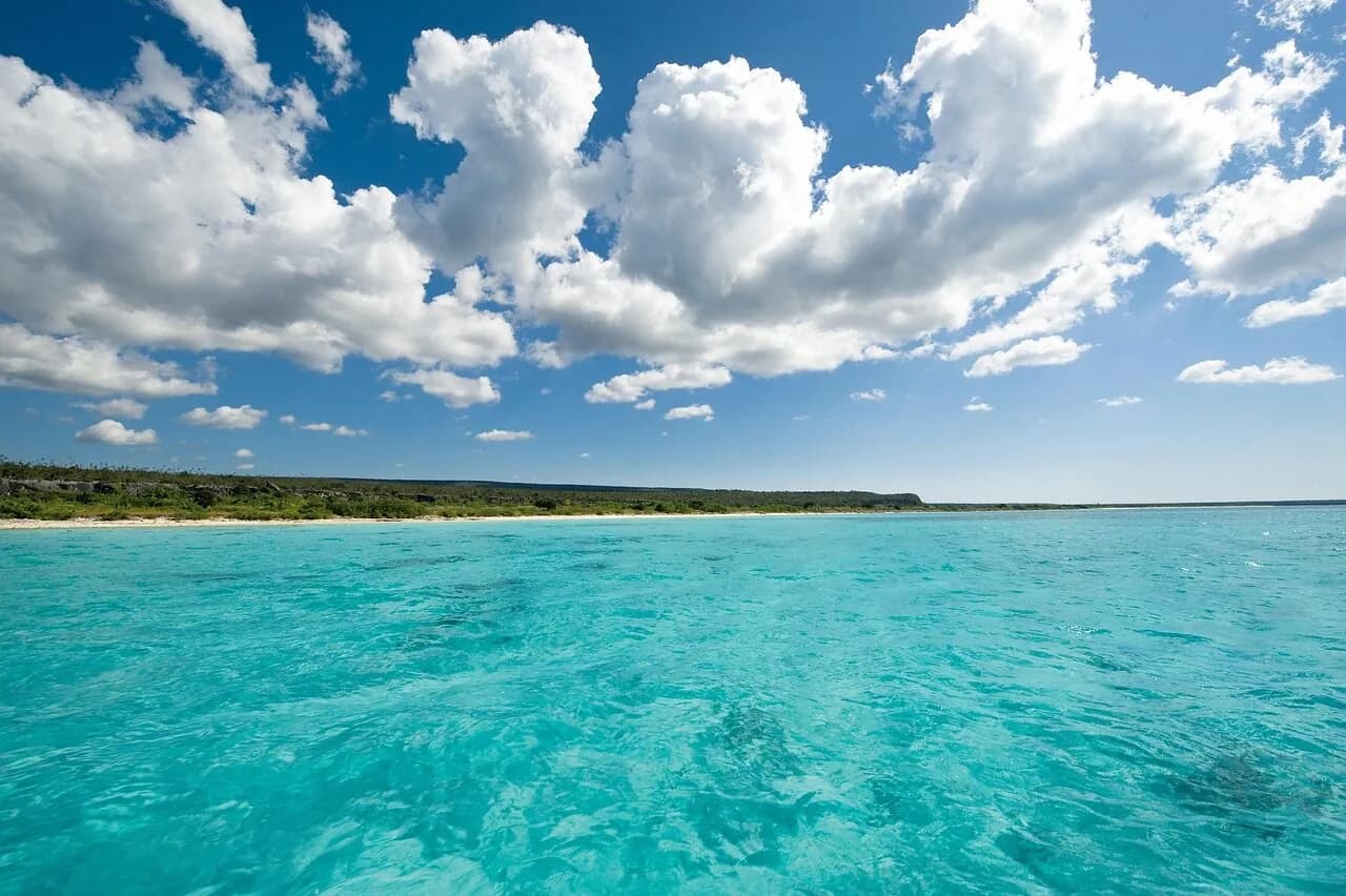 Clear turquoise shallows meeting a white-sand Caribbean beach