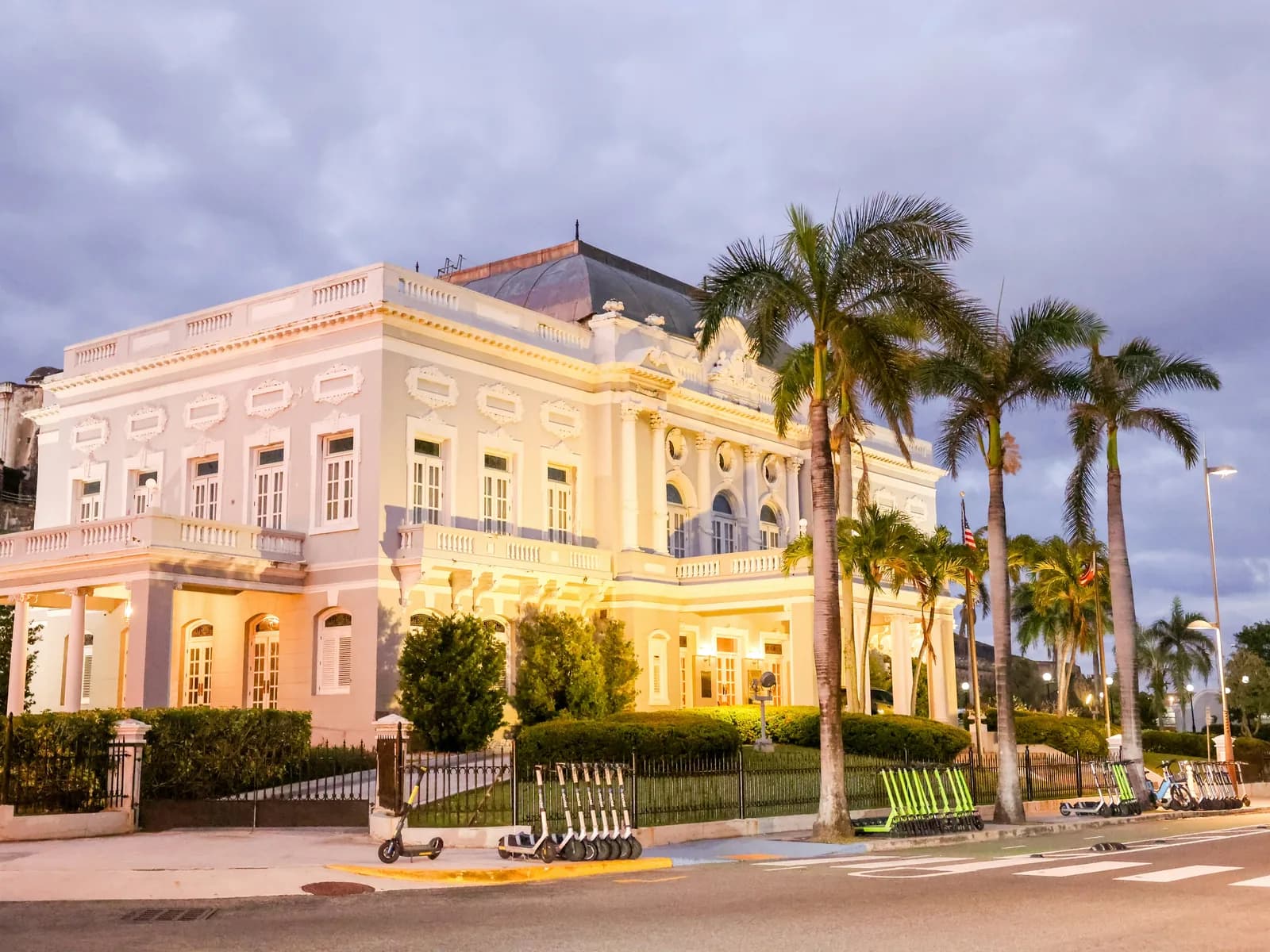 An ornate historic building with palm trees in San Juan