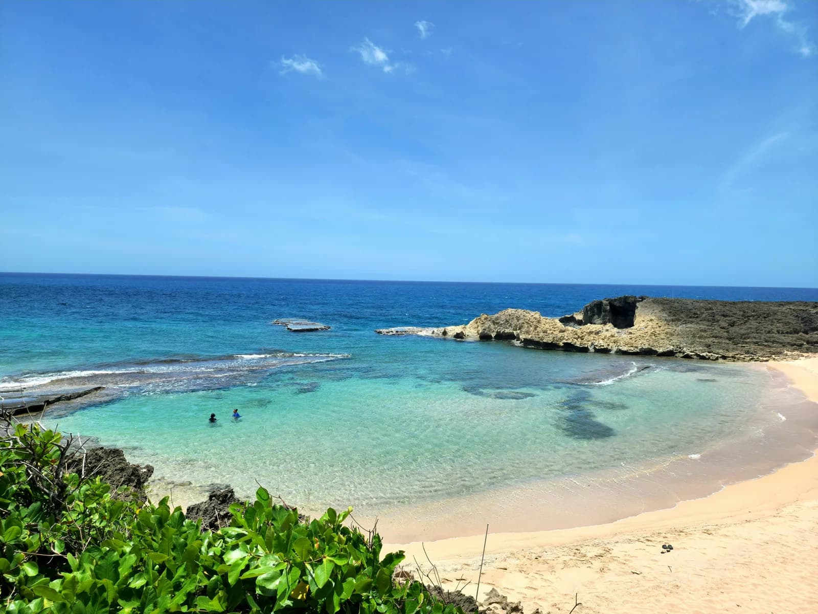 Clear shallow water and a rocky point at a sheltered Puerto Rico cove