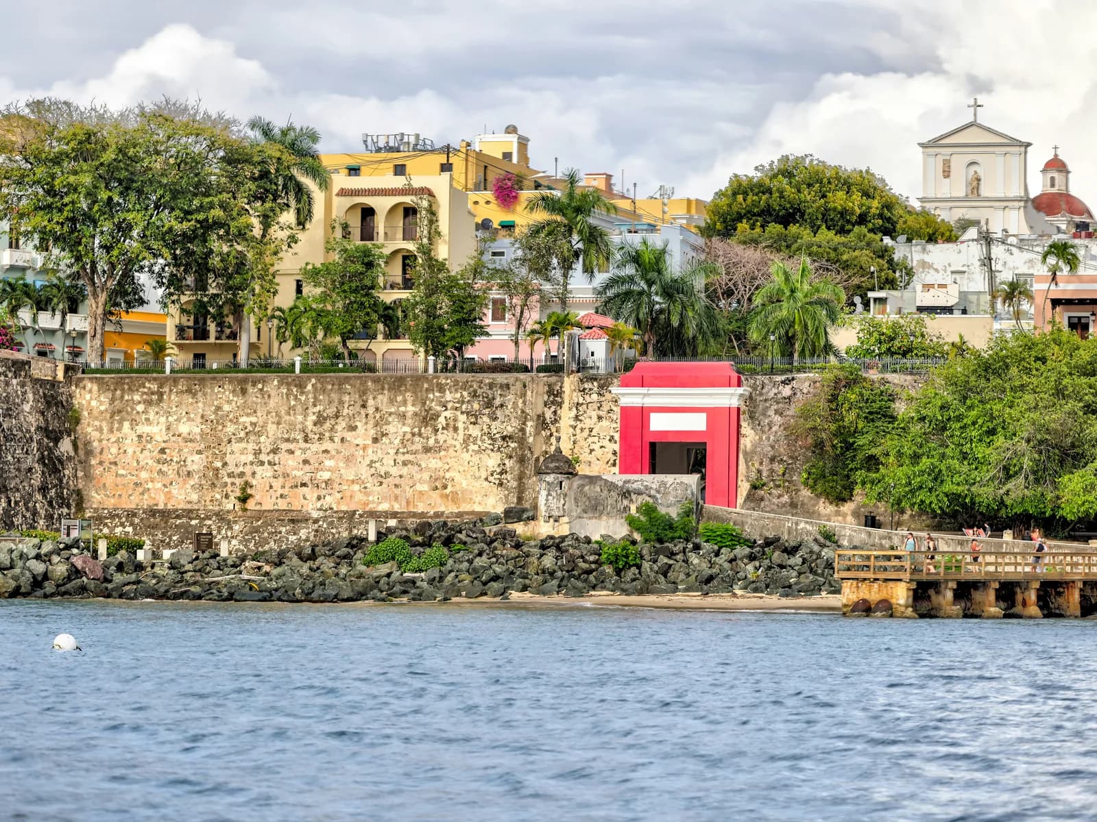 The red San Juan Gate in the old city walls seen from the bay