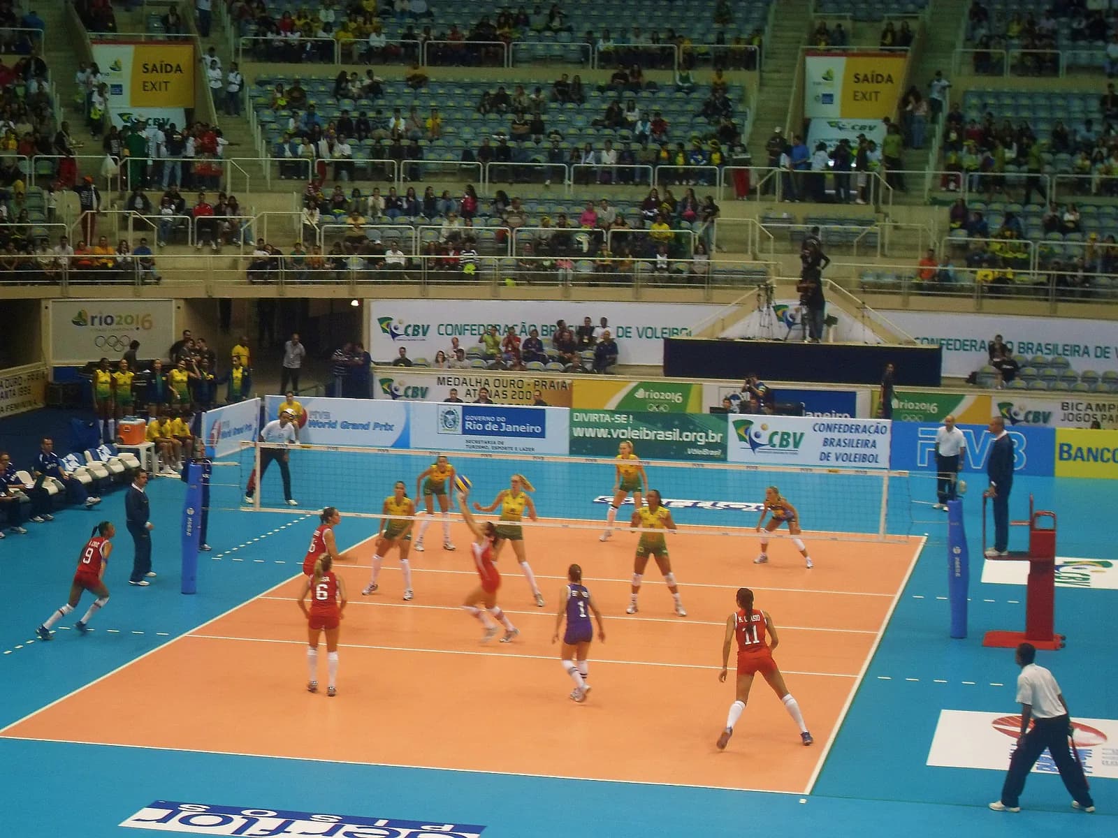 Puerto Rico’s women’s volleyball team in red receiving a serve against Brazil