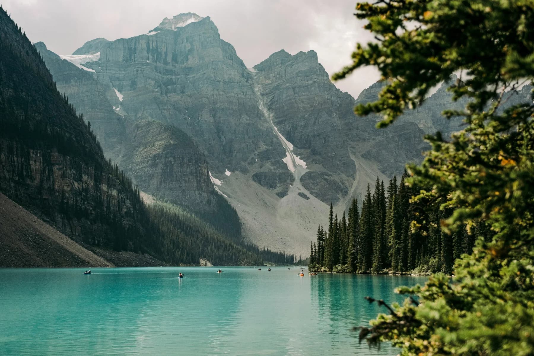 Rocky peaks and evergreen trees framing a turquoise lake