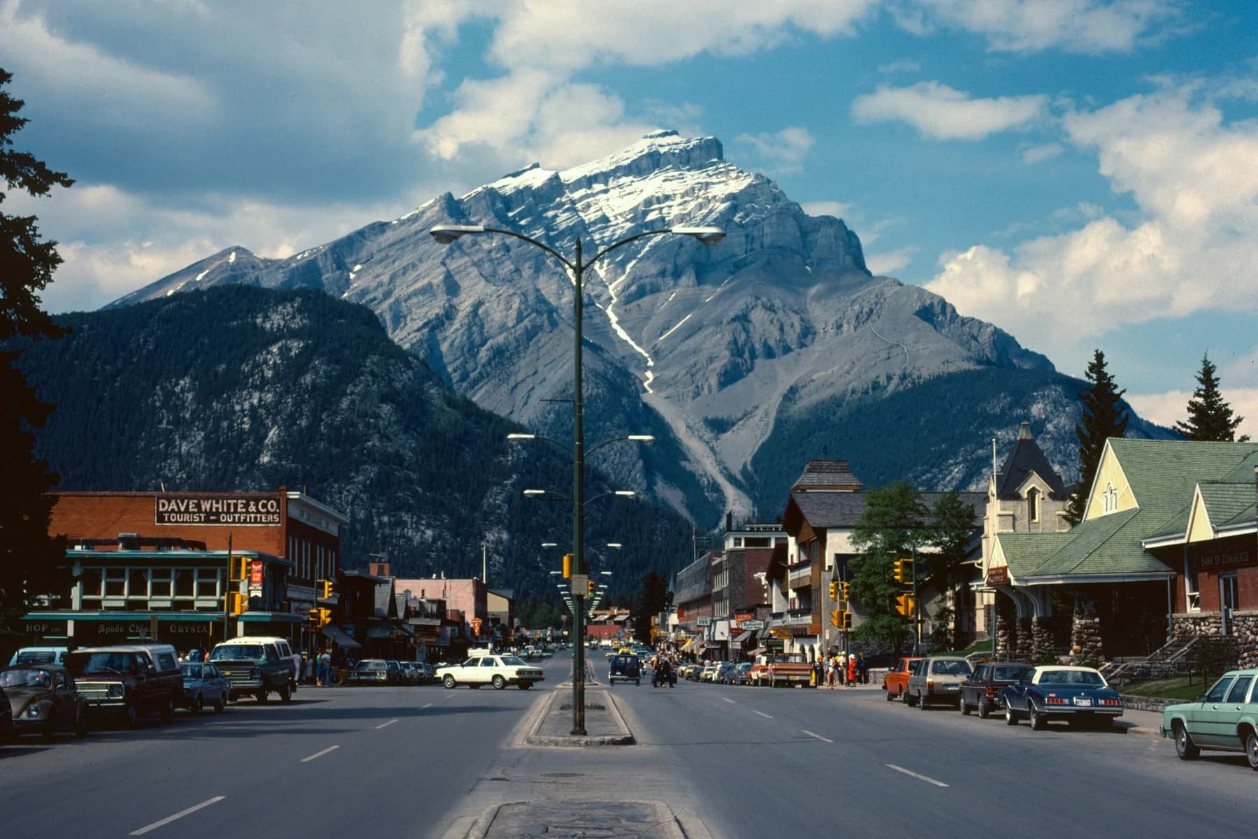A mountain rises behind a lively town street