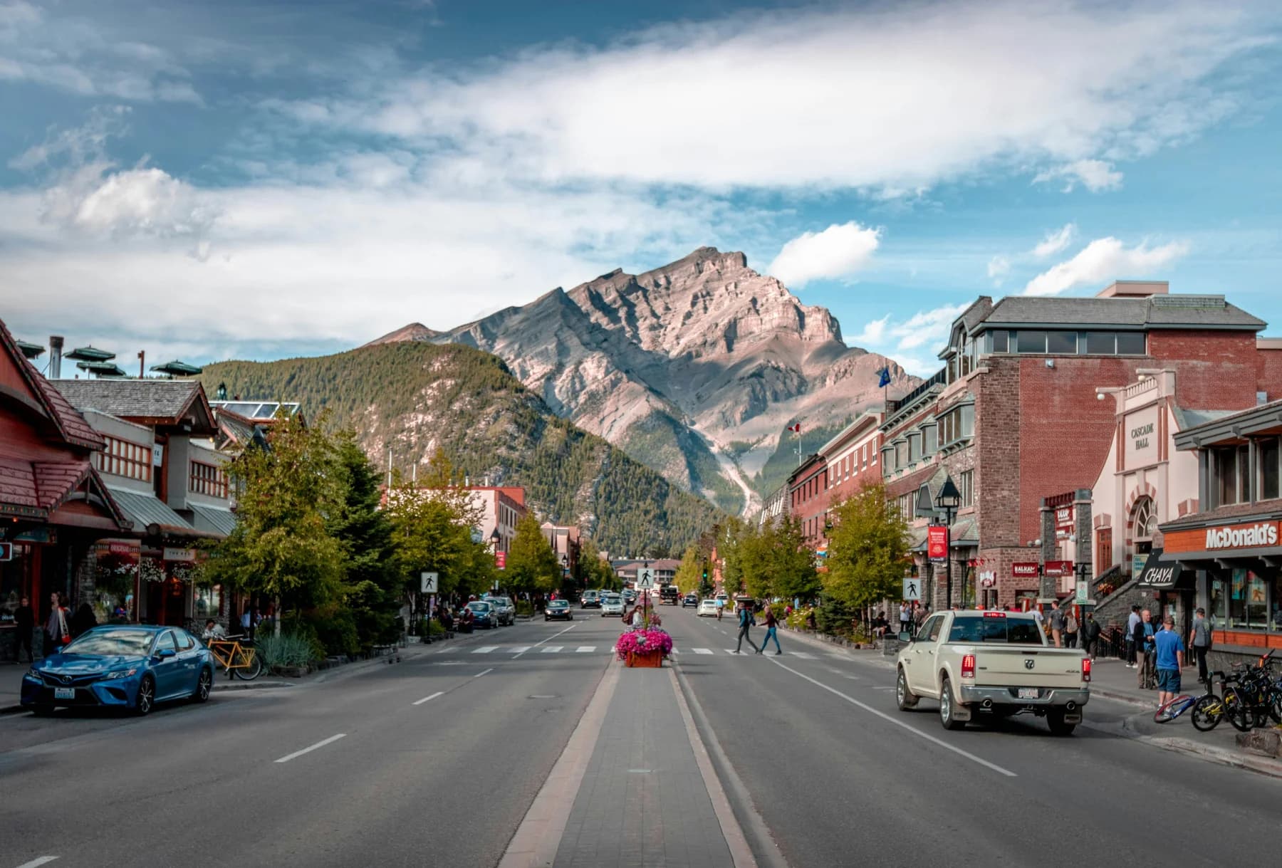 Shops and a mountain backdrop along a town street