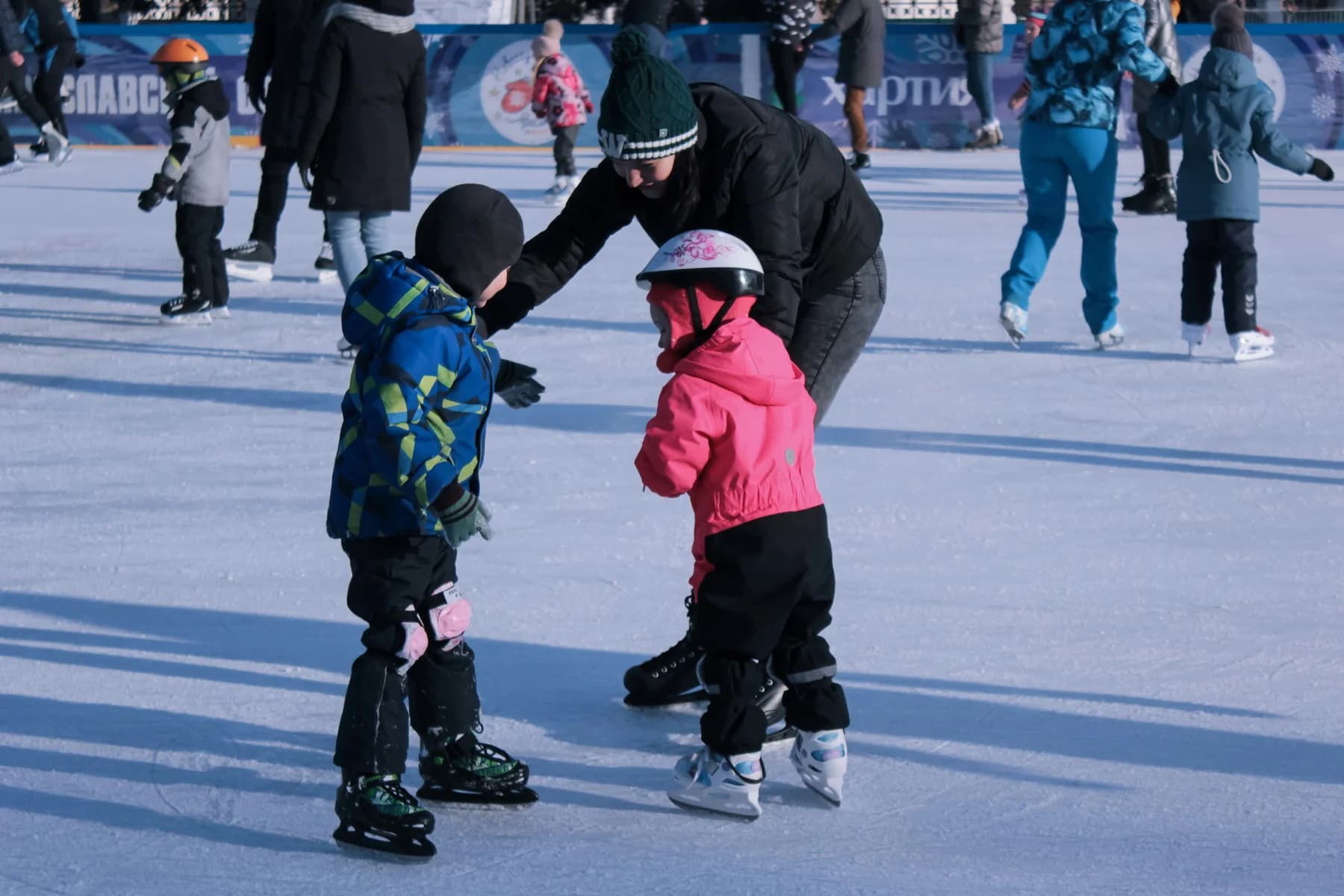 Families skating together on an outdoor ice rink