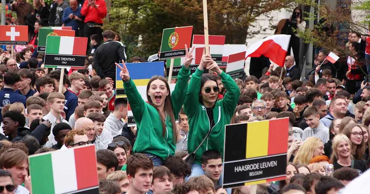 Athletes waving national flags at an international tournament opening ceremony