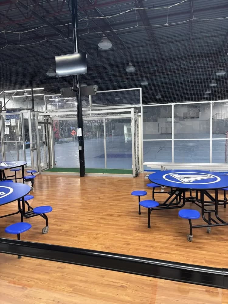 Tables and gathering space beside the courts at Vision Sport Centre