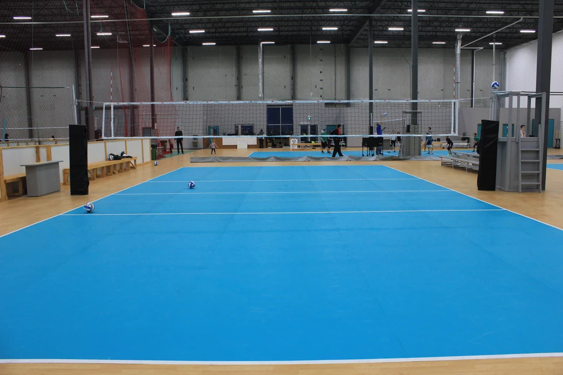Blue volleyball courts and players at Volleydome Calgary